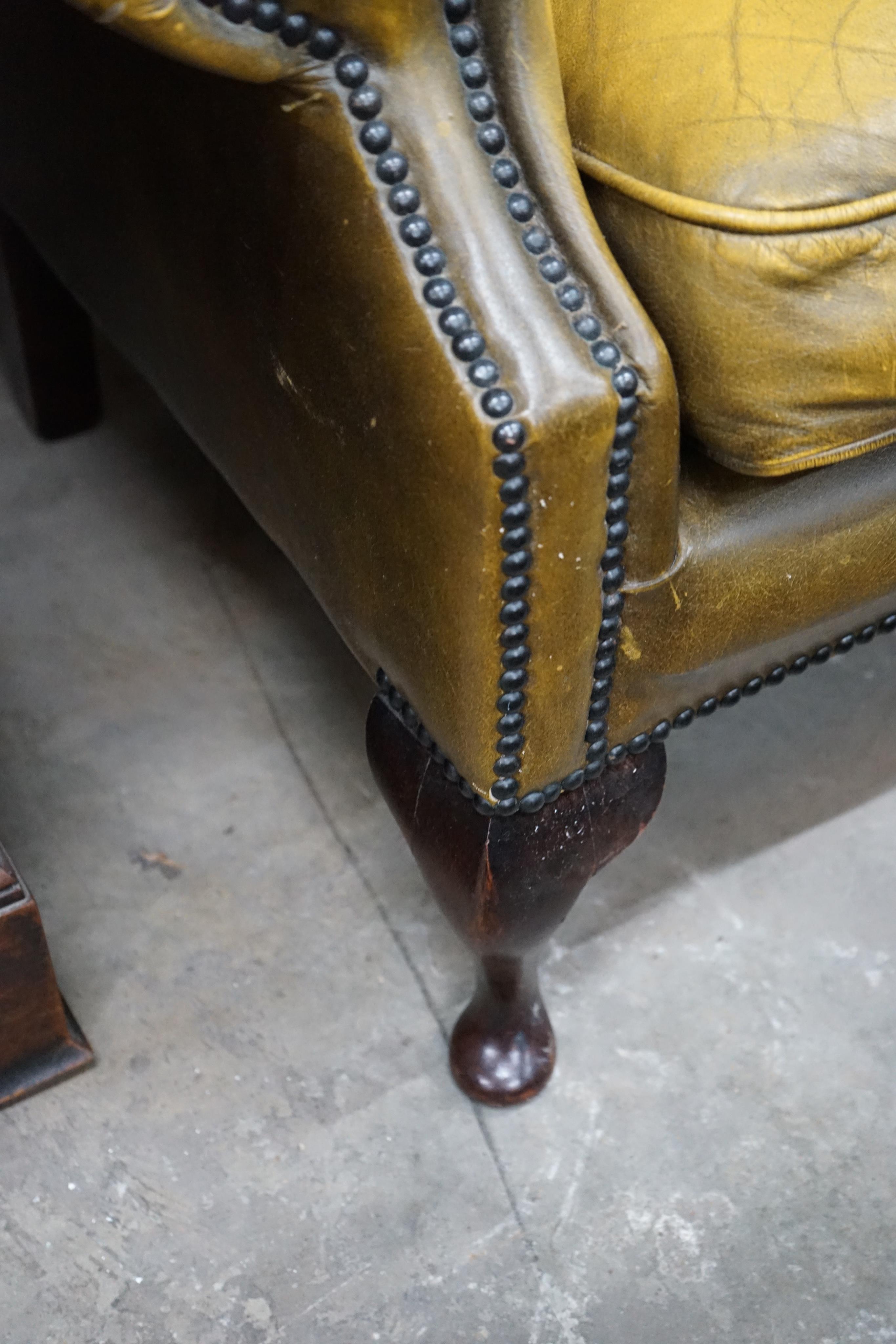 A Victorian style green leather wing armchair, width 82cm depth 76cm height 100cm